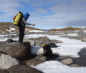 A man and a woman sampling soils and recording GPS locations in the field