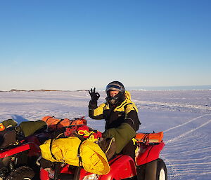 Antarctic expeditioner on quad bike