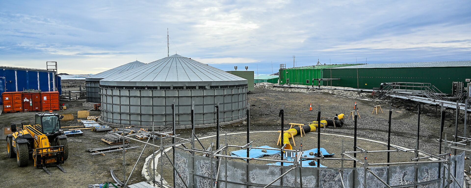 The tanks first, grey wall panels held firmly in position by scaffolding