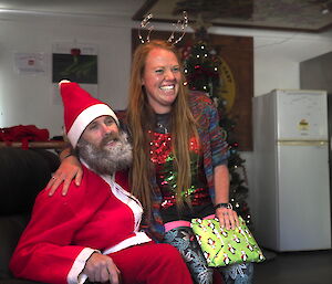 Mel sitting on Santa’s lap with her gift on Christmas Day at Macca