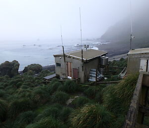 Hurd Point hut on Macquarie Island showing LPG gas bottles and water tank at the rear of the hut