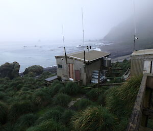 Hurd Point hut on Macquarie Island showing LPG gas bottles and water tank at the rear of the hut