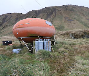 Waterfall Bay hut showing the water collecting coil and LPG gas bottles