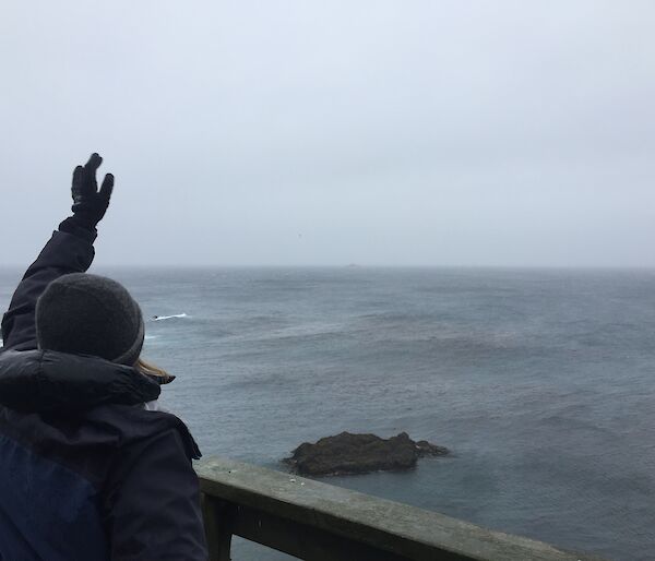 Ali Dean waving to the ship from the Ham Shack on Macquarie Island