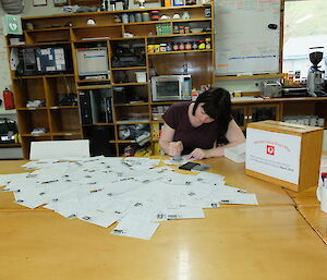 Cathryn our Postal Officer for the year post marking letters and postcards in the Mess at Macca