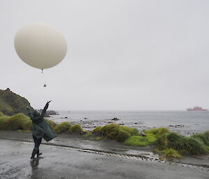 A weather balloon release with the ship in the background