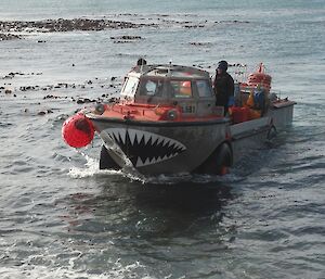 An amphibious vehicle lands on a beach