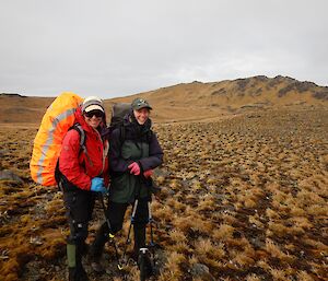 Two women stand in hiking gear on a walking track