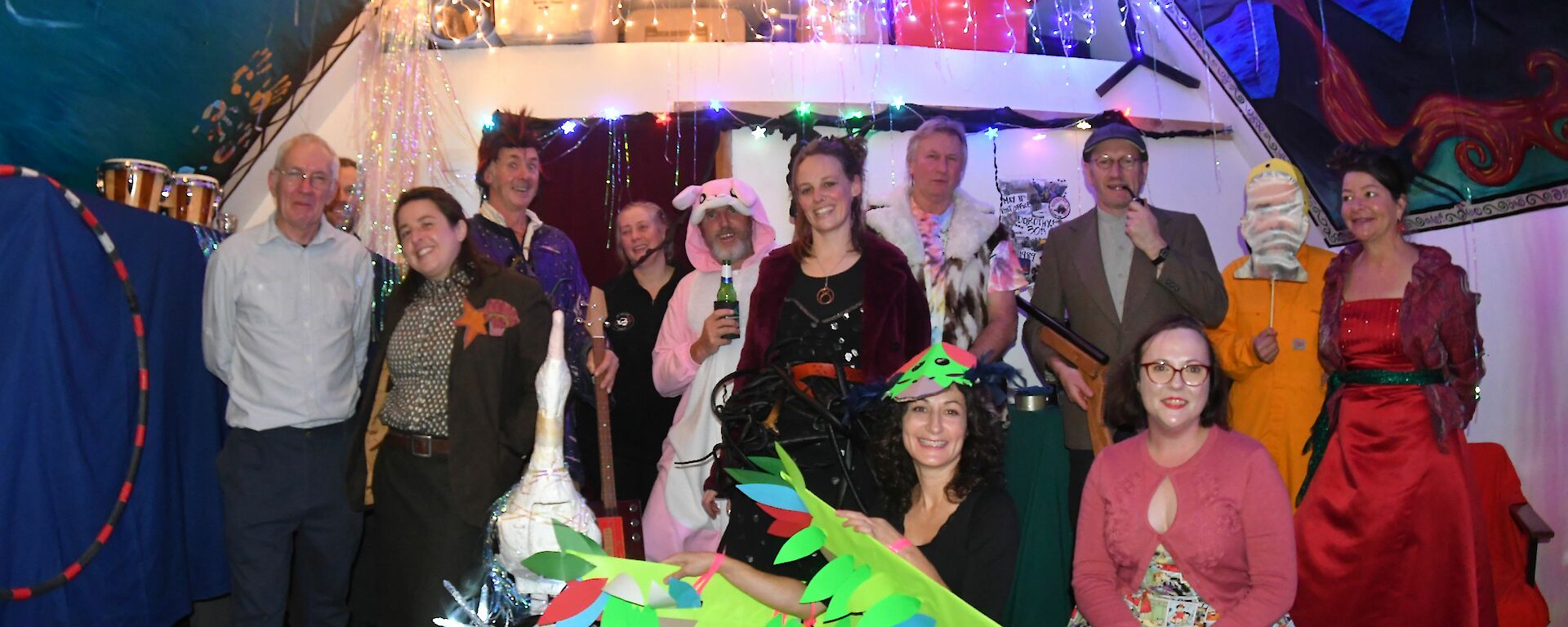 a group of people in fancy dress pose for a group photo