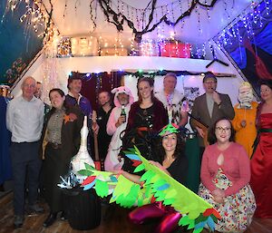 a group of people in fancy dress pose for a group photo