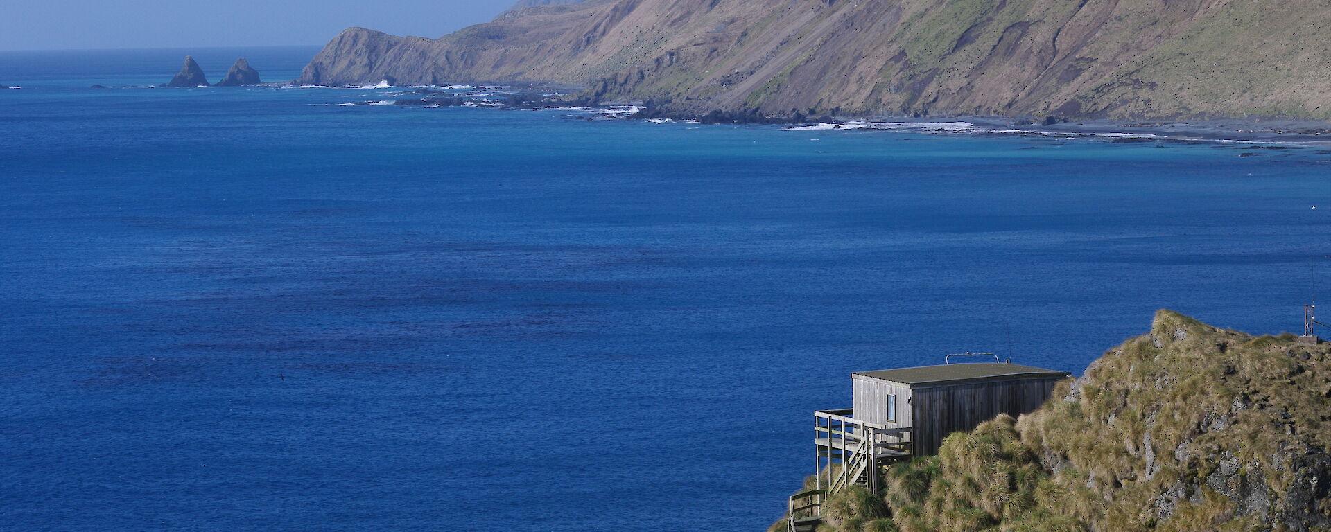 building on hill overlooking ocean
