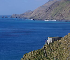 building on hill overlooking ocean