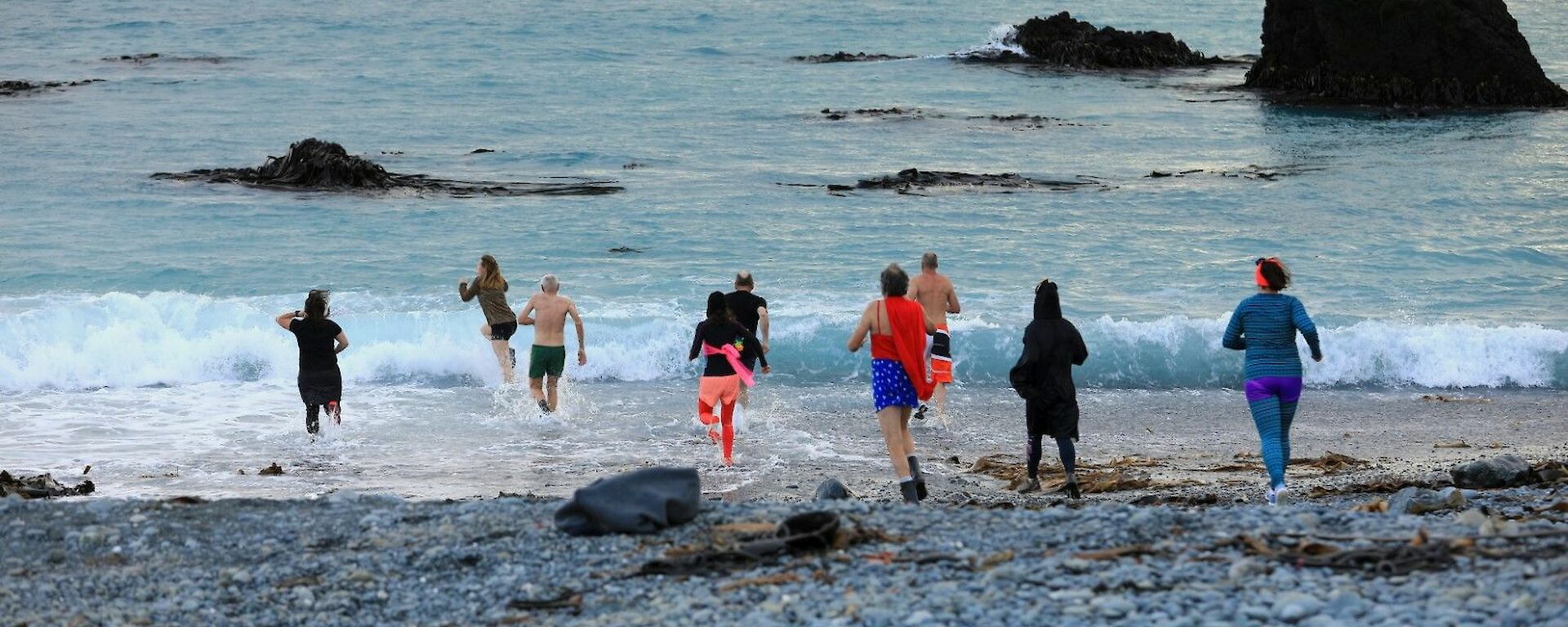 Nine people run into the ocean