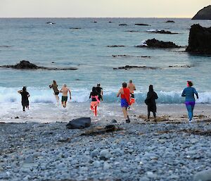 Nine people run into the ocean