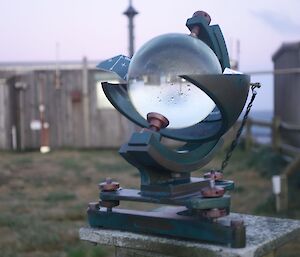 An instrument that looks like a crystal ball standing on a pedastal