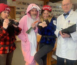 Four people are in costume, two women as Rangers, a man in a pink rabbit costume and a man in a Scientists coat.