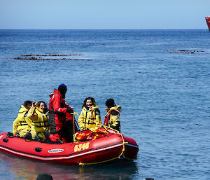 Departing expeditioners in inflatable rubber boat