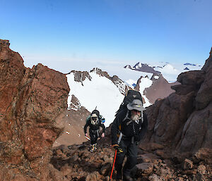 Two men climbing a mountain