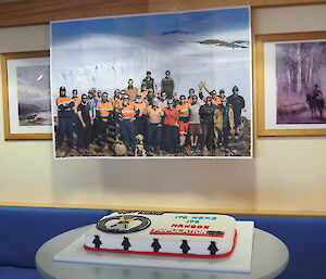 A cake and poster of people