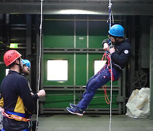 Mawson Technical Search and Rescue team members practicing their rope climbing skills indoors.