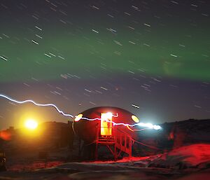 Aurora over melon field hut — by Mawson Bureau of Meteorology Tech Leon.