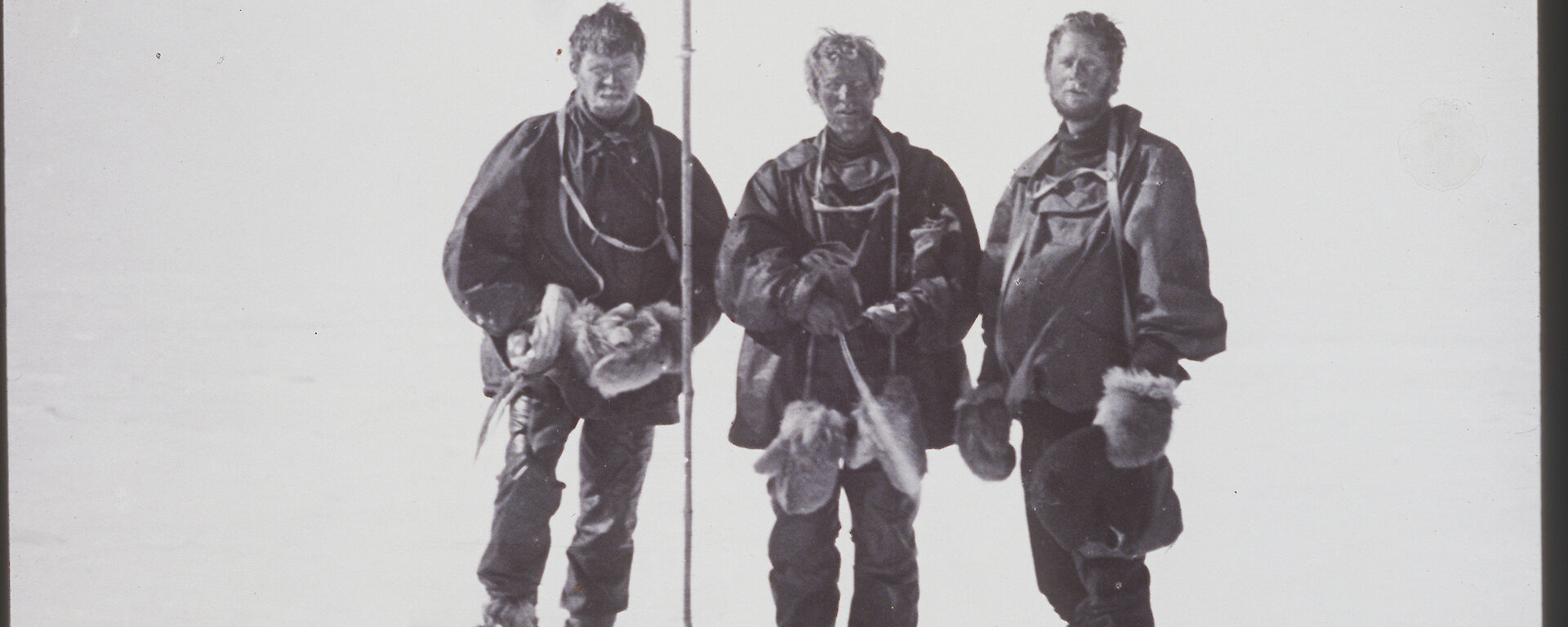 Raising the flag at the South Magnetic Pole — Alistair Forbes Mackay, T.W. Edgeworth David, and Douglas Mawson during the 1907–1909 Nimrod Expedition.