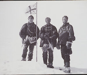 Raising the flag at the South Magnetic Pole — Alistair Forbes Mackay, T.W. Edgeworth David, and Douglas Mawson during the 1907–1909 Nimrod Expedition.