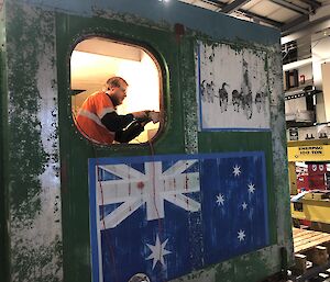 Mawson winter electrician Warren ‘Wazza’ Arnold hard at work on internal repairs of Rumdoodle Hut.