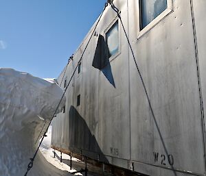 A silver-clad building with a wave of snow