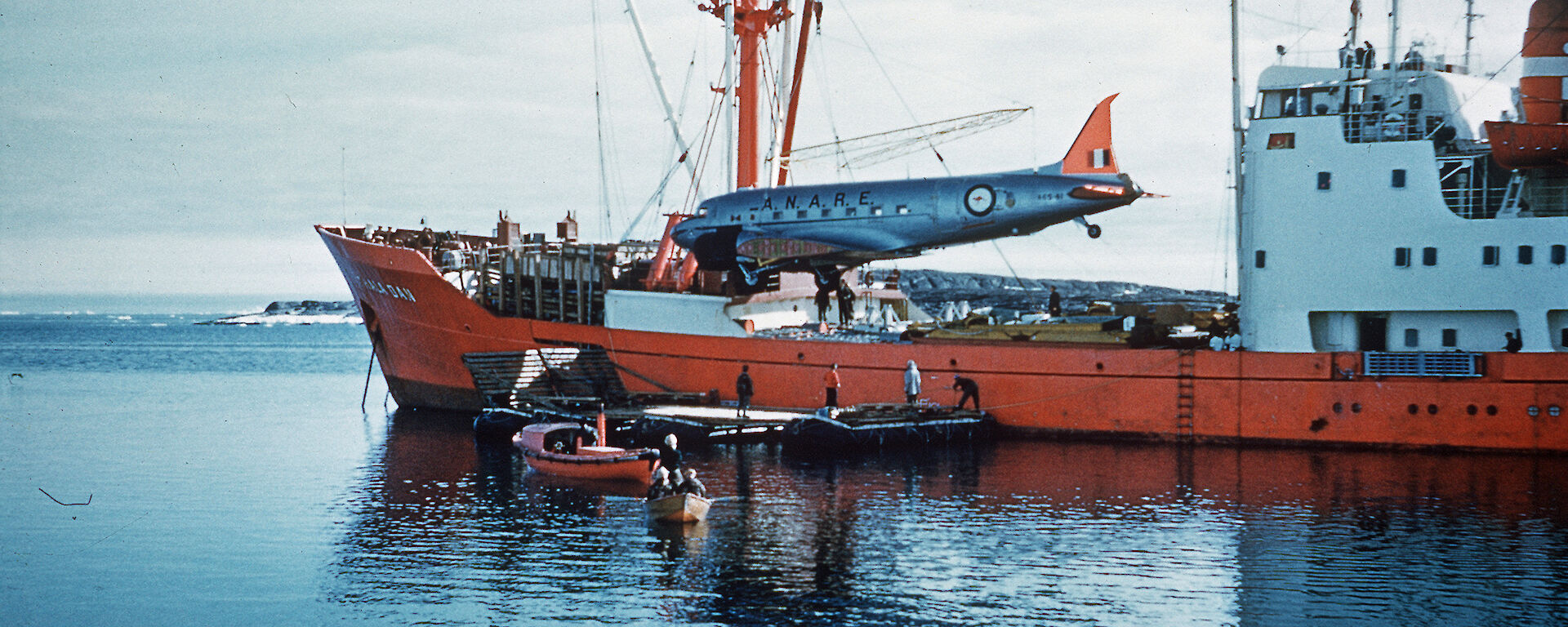 The Dakota aircraft being unloaded from the Thala Dan at Mawson in 1960.