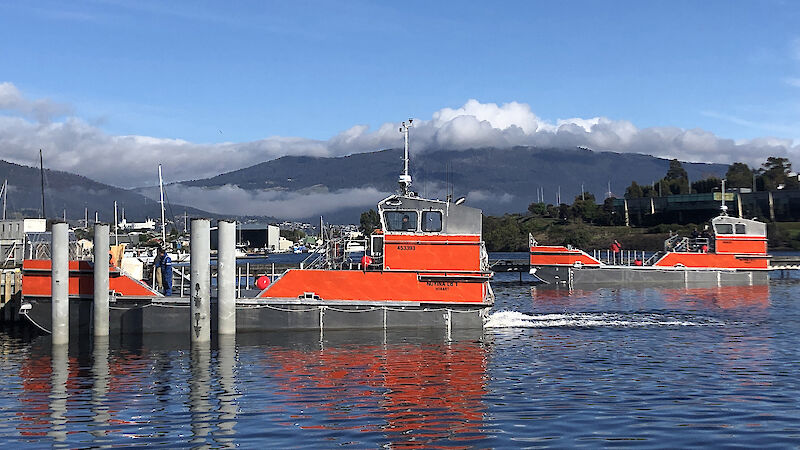 The two Antarctic landing barges undergoing open water trials in the River Derwent.