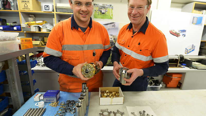 Technical officers in the instrument workshop with a ice core drill head.