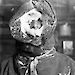 Antarctic expeditioner from 1914 with ice-encrusted hood around his face.
