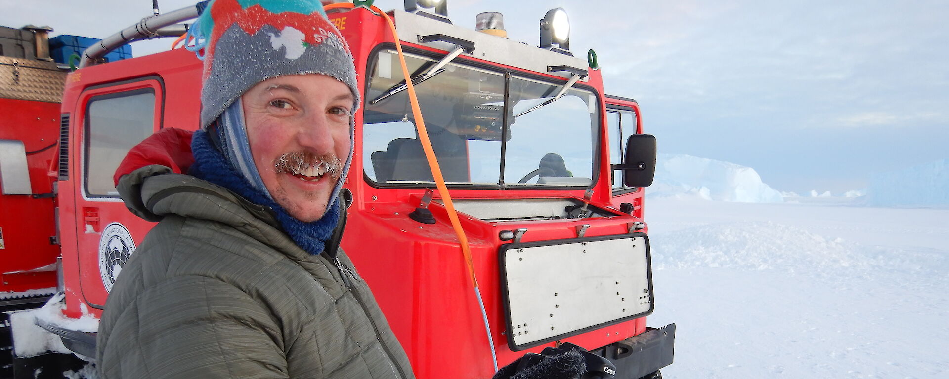 Neil Brown standing beside a Hagglund vehicle.