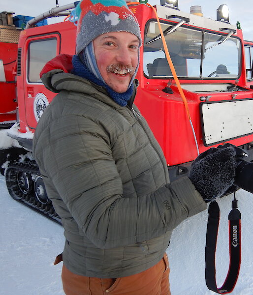 Neil Brown standing beside a Hagglund vehicle.