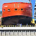 The bow of the Nuyina towering over a gate between the dry and wet docks.