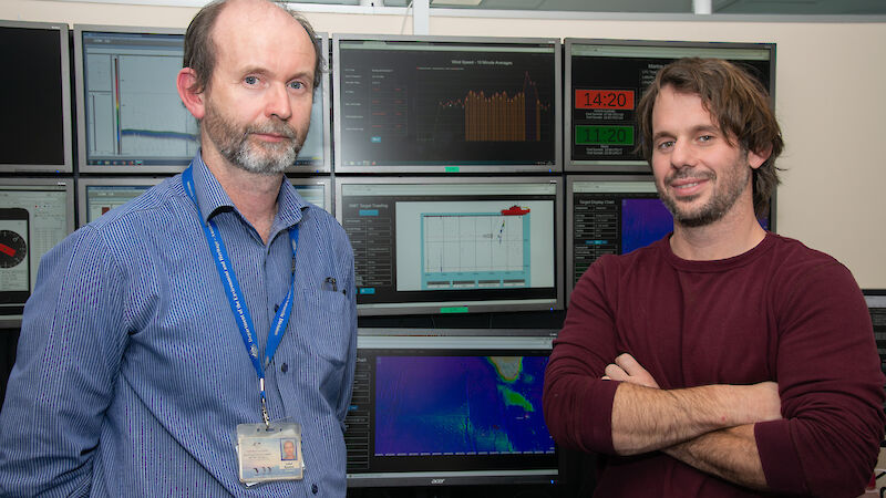 Two men in front of computer screens set up to mimic the Aurora Australis science control room and deliver ‘data in real time’.