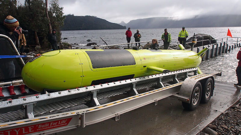 The 7 metre long yellow autonomous underwater vehicle on a trailer backing into Lake St Clair.