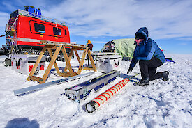 Scientist extracts a core from the ice core drill at Law Dome during a project in 2015.