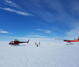 A twin otter and AS350 helicopter on the ice sheet.