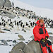 Woman at a penguin colony in Antarctica.