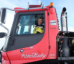 Anthony Hull in the cab of a Pisten Bully tractor.