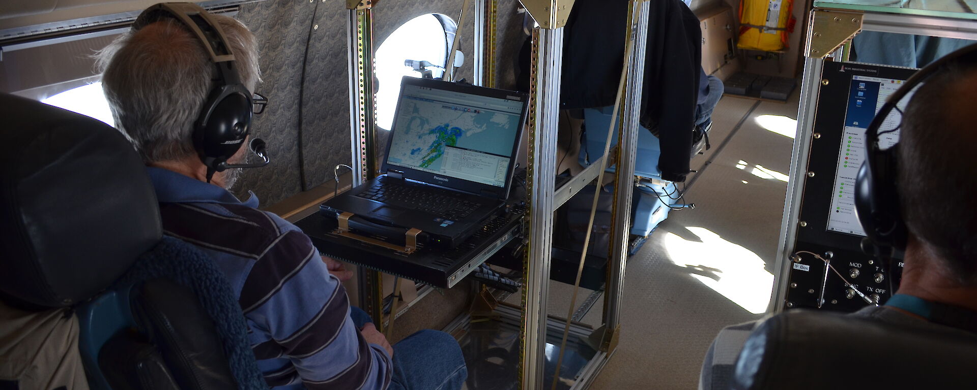 Scientists on board the NSF/NCAR HIAPER Gulfstream V studying real-time data collected by the aircraft’s cloud radar.