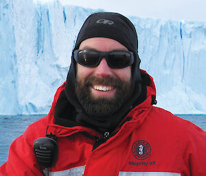 Rowan Trebilco in front of an iceberg.