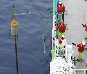 Deploying the piston corer during Sabrina Sea Floor Survey.