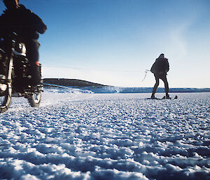 The Matchless motorcycle towing skier Neville Dippell on the sea ice at Mawson’s Horseshoe Harbour.