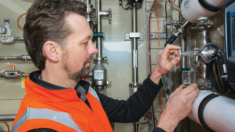 Engineer, Michael Packer, in the Advanced Wastewater Treatment Plant built inside two shipping containers.