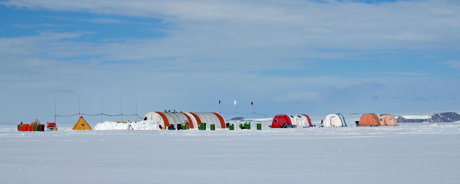 A campsite of semi-circular and polar pyramid tents on the Amery Ice Shelf in 2010.