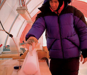 Dr Mark Curran processes an ice core in Antarctica.