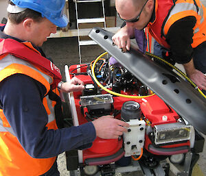 Kym and a scientist make the final inspections to a remotely operated vehicle (ROV) before its first test deployment into water